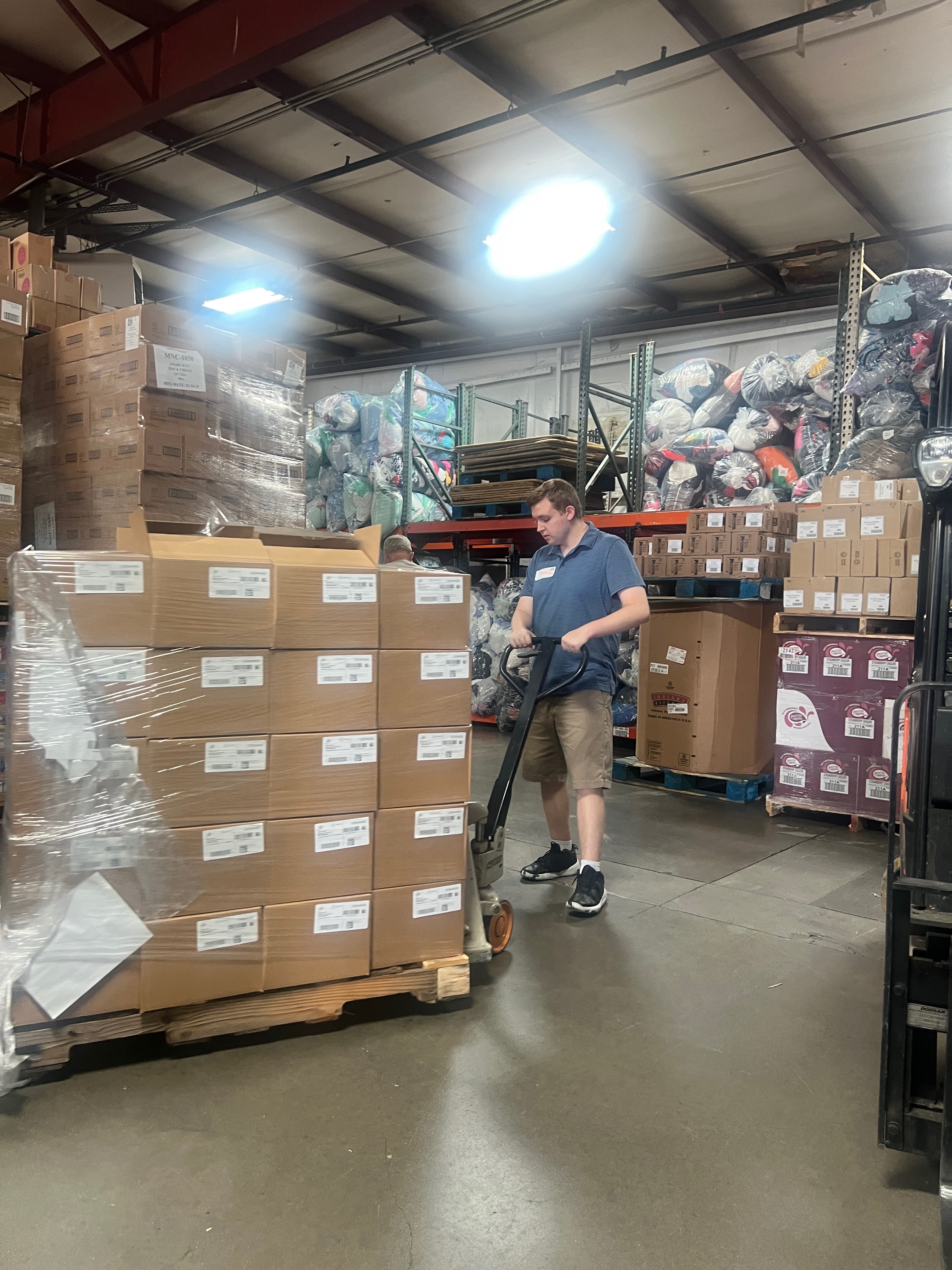 Landon Using Pallet Jack at Master Provisions
